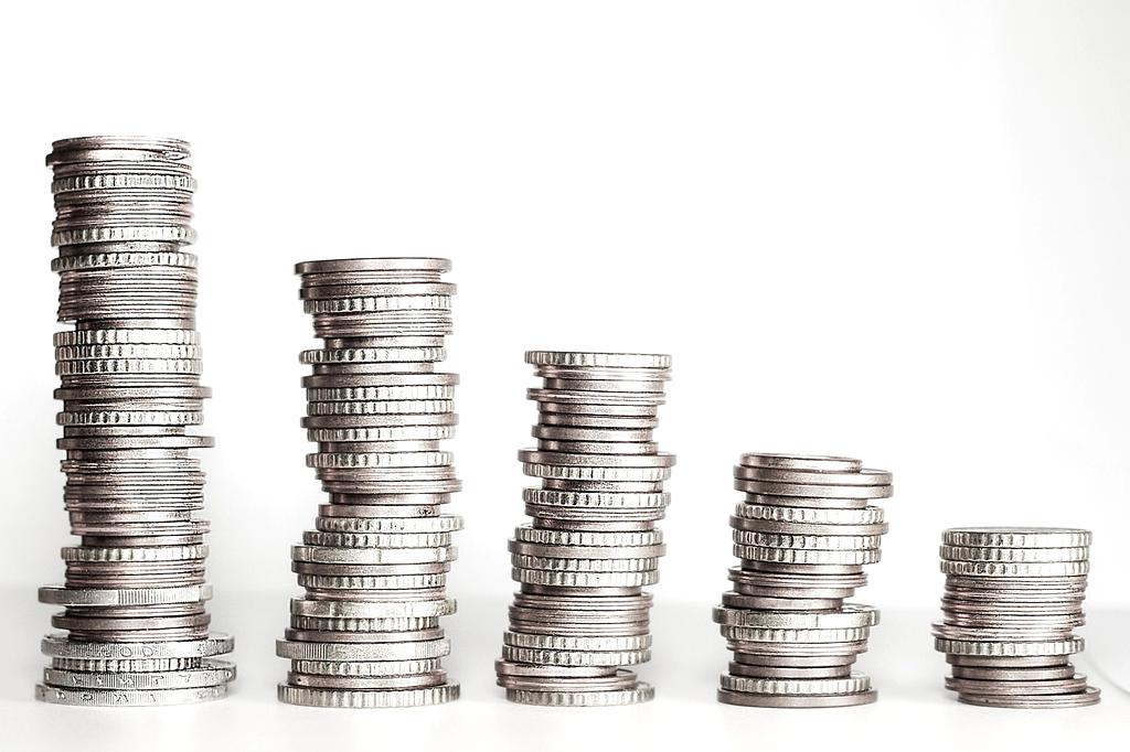 Close-up of euro banknotes and coins on a desk